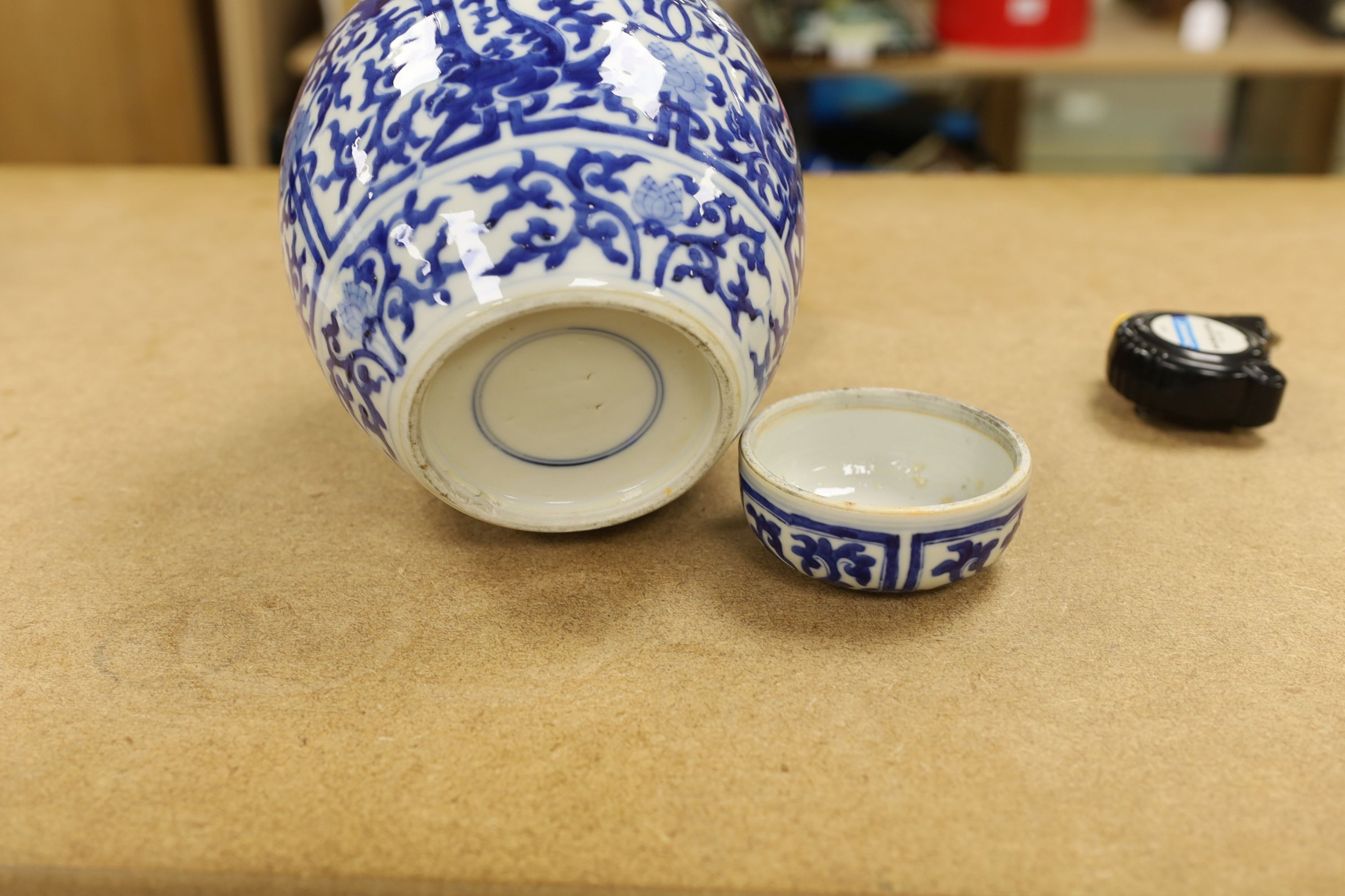 A pair of Chinese blue and white ginger jars and covers, 22cm, On stands
